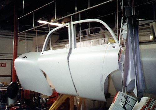 Doors and trunk lid hanging from a rack